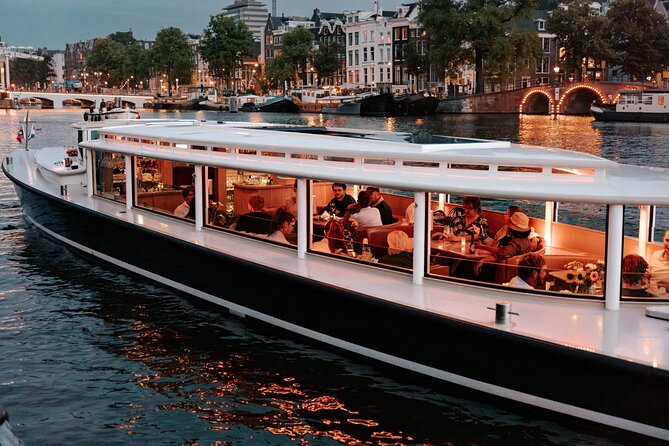 Amsterdam Small-Group Evening Canal Cruise Including Wine, Craft Beer, Cheese - Boarding a small boat with a social atmosphere