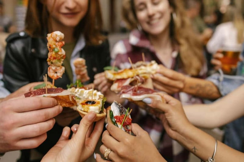 Barcelona: Food Walking Tour with Tapas and Wine - Nine tapas, from bravas to paella