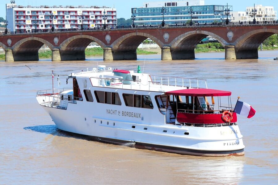 Bordeaux: River Garonne Cruise with Glass of Wine and Canelé - Returning Past Porte Cailhau