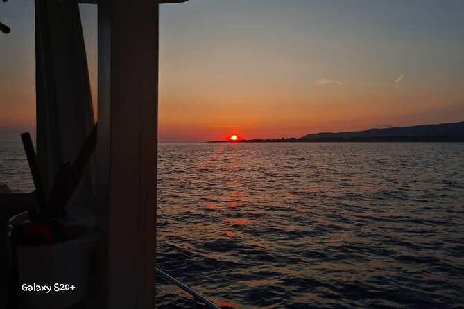 Dreamy Cruise sunset tour with dinner and unlimited wine! - Xi Beach after dark: a 40-minute night swim