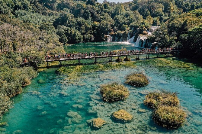 From Split: Krka Waterfalls, Food & Wine Tasting Tour - Walking beside the water at Krka National Park