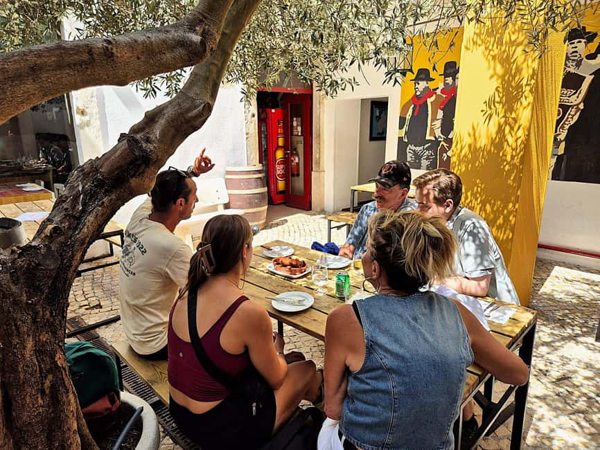 Lisbon Small-Group Food & Wine Tour Eat & Drink like a Local - Chouriço flame, red wine, and the appeal of small stops