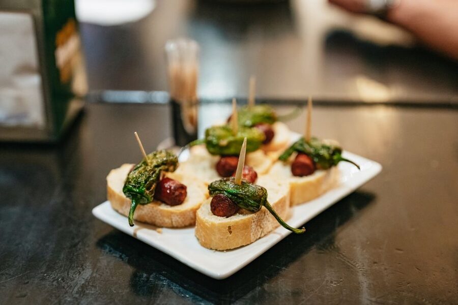 Madrid: Food & Wine Tour with 10 Tapas & 4 Drinks Included - Stop one: a market-style restaurant sets the table