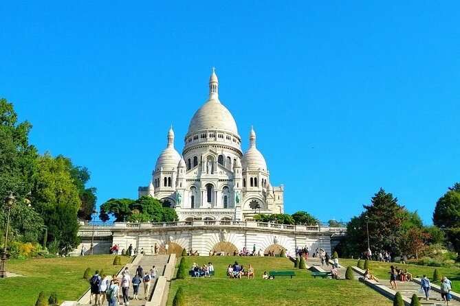 Montmartre Hill French Gourmet Food and Wine Tasting Walking Tour - Starting below the hill at Moulin Rouge