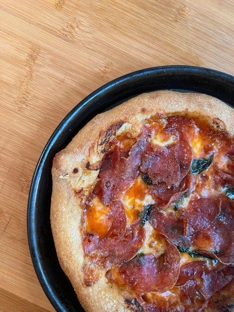 Pizza and Tiramisu Cooking Class with Wine in Milan - Prosecco, red wine, and a shared table