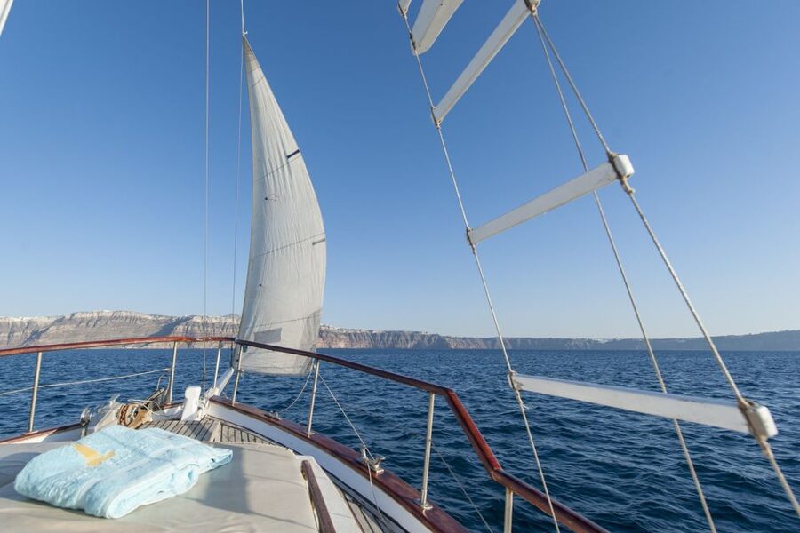 Santorini: Traditional Wooden Boat Tour with Meal and Wine - The Akrotiri Lighthouse and the volcanic caldera